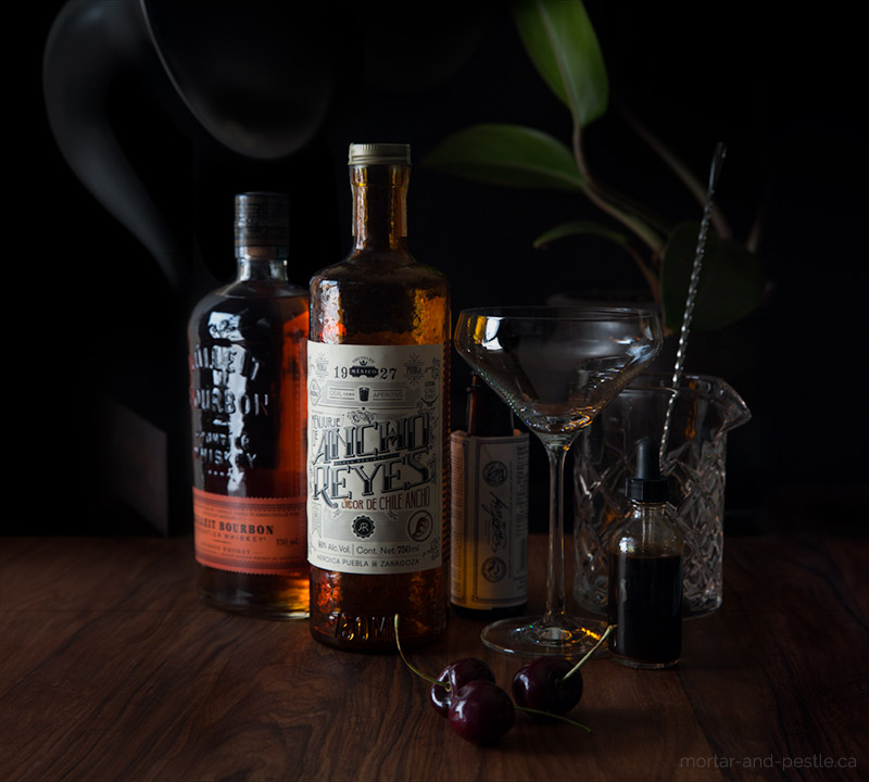 A Mexican ancho chile liqueur and home-made cocktail cherries put a spicy, smoky spin on the classic Manhattan.
